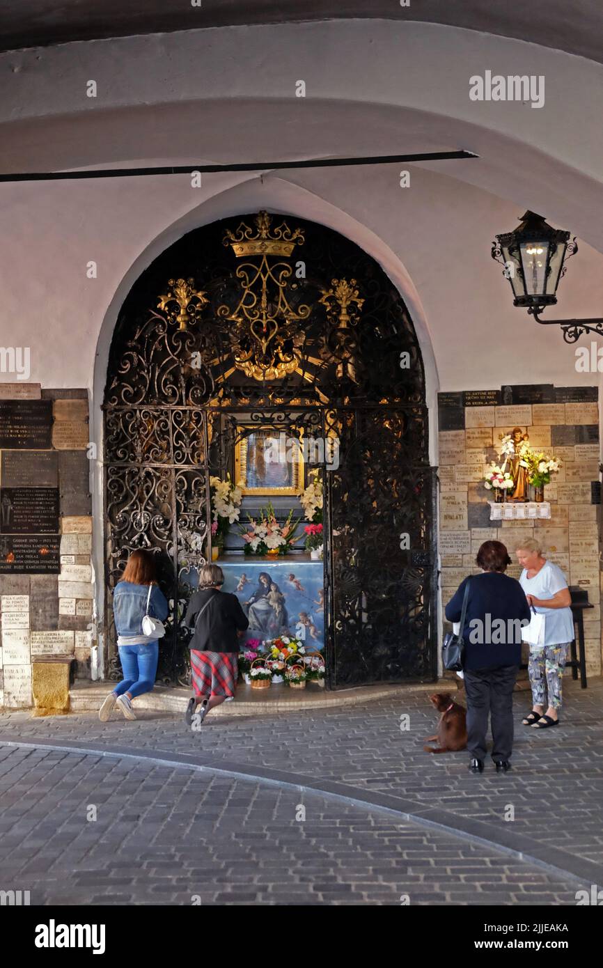 Famous landmarks, Stone gate, altar in chapel of Mother of God from the Stone Gate, Zagreb, women in prayer, Croatia Stock Photo