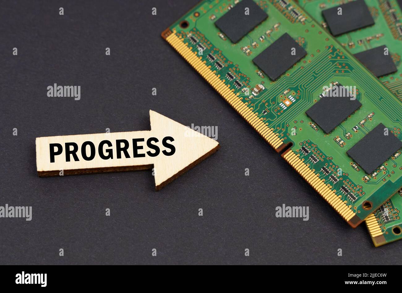 Technology and computer concept. On the black surface lies RAM and an arrow with the inscription - Progress Stock Photo
