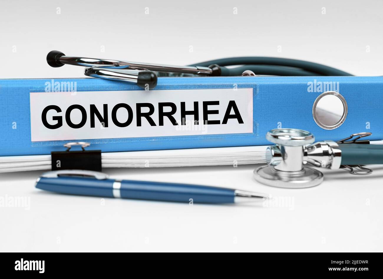 Medicine concept. On the book is a stethoscope and a folder with the inscription - GONORRHEA Stock Photo