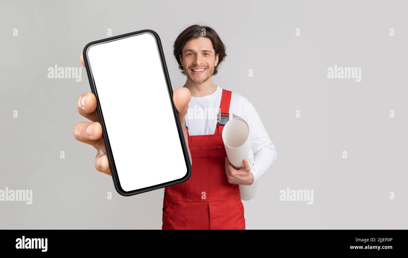 Worker Holding Construction Plan And Smartphone With Blank Screen Stock Photo