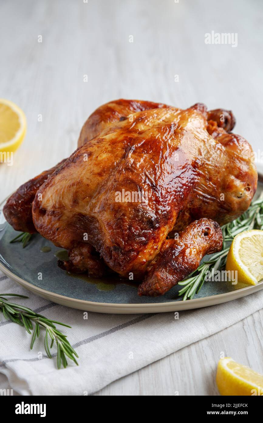 Homemade Lemon And Herb Rotisserie Chicken On A Plate Side View Close