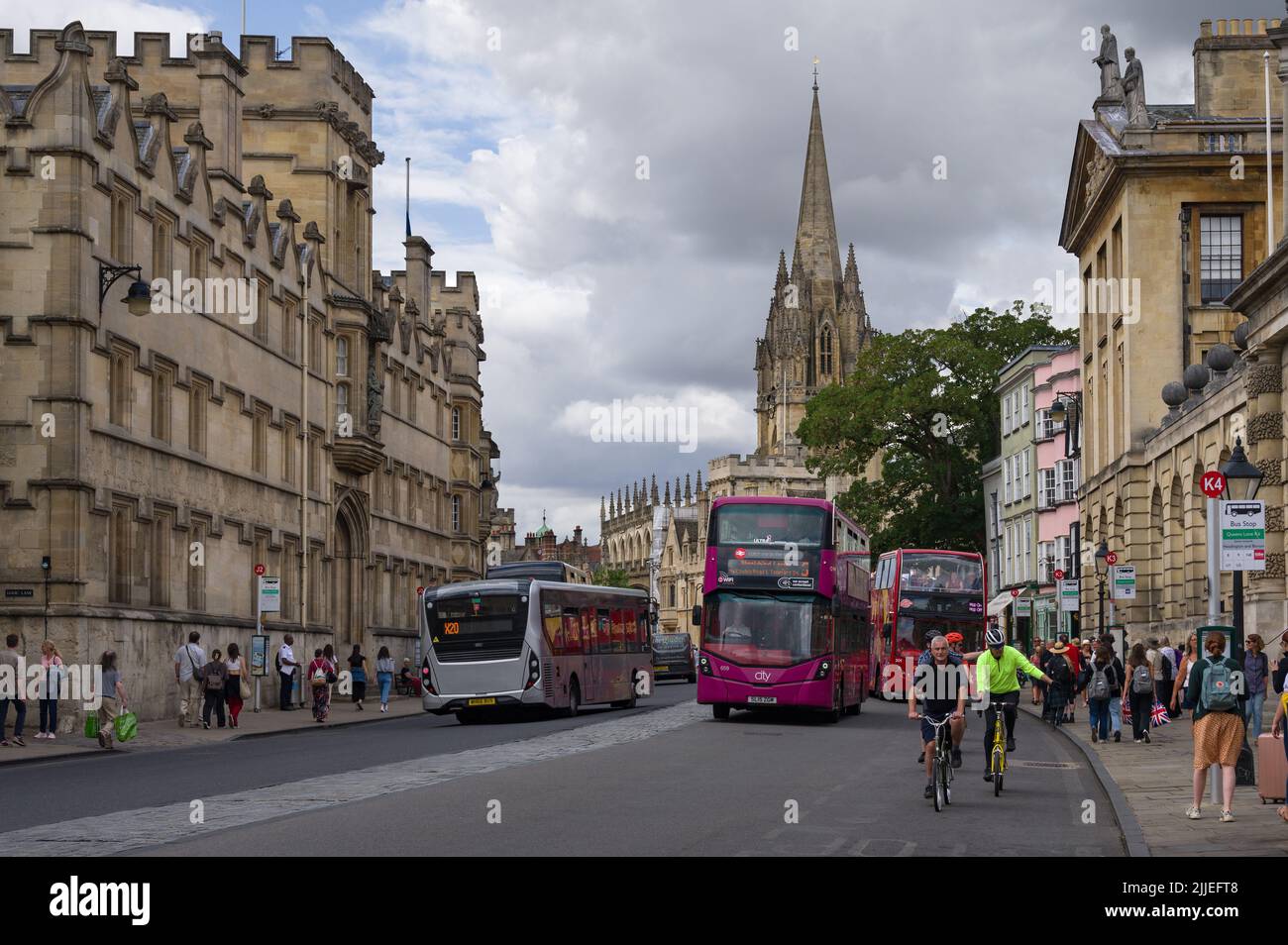 View down High Street tourists and buildings, with University Church of St Mary the Virgin in background, Oxford Oxfordshire, UK Stock Photo