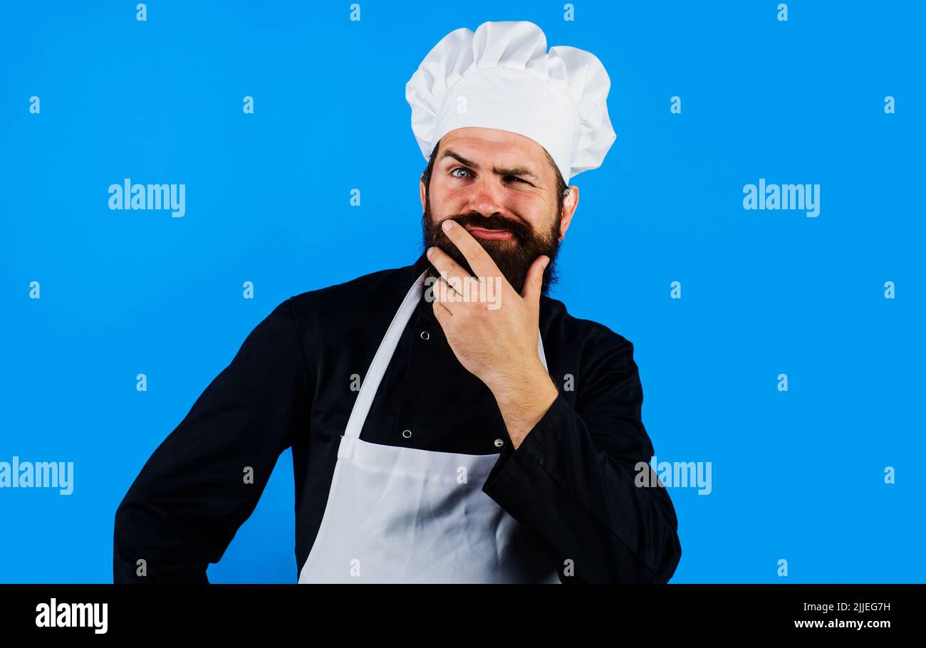 Man chef, cook or baker in uniform thinks what to cook. Cooking, profession and inspiration concept. Stock Photo