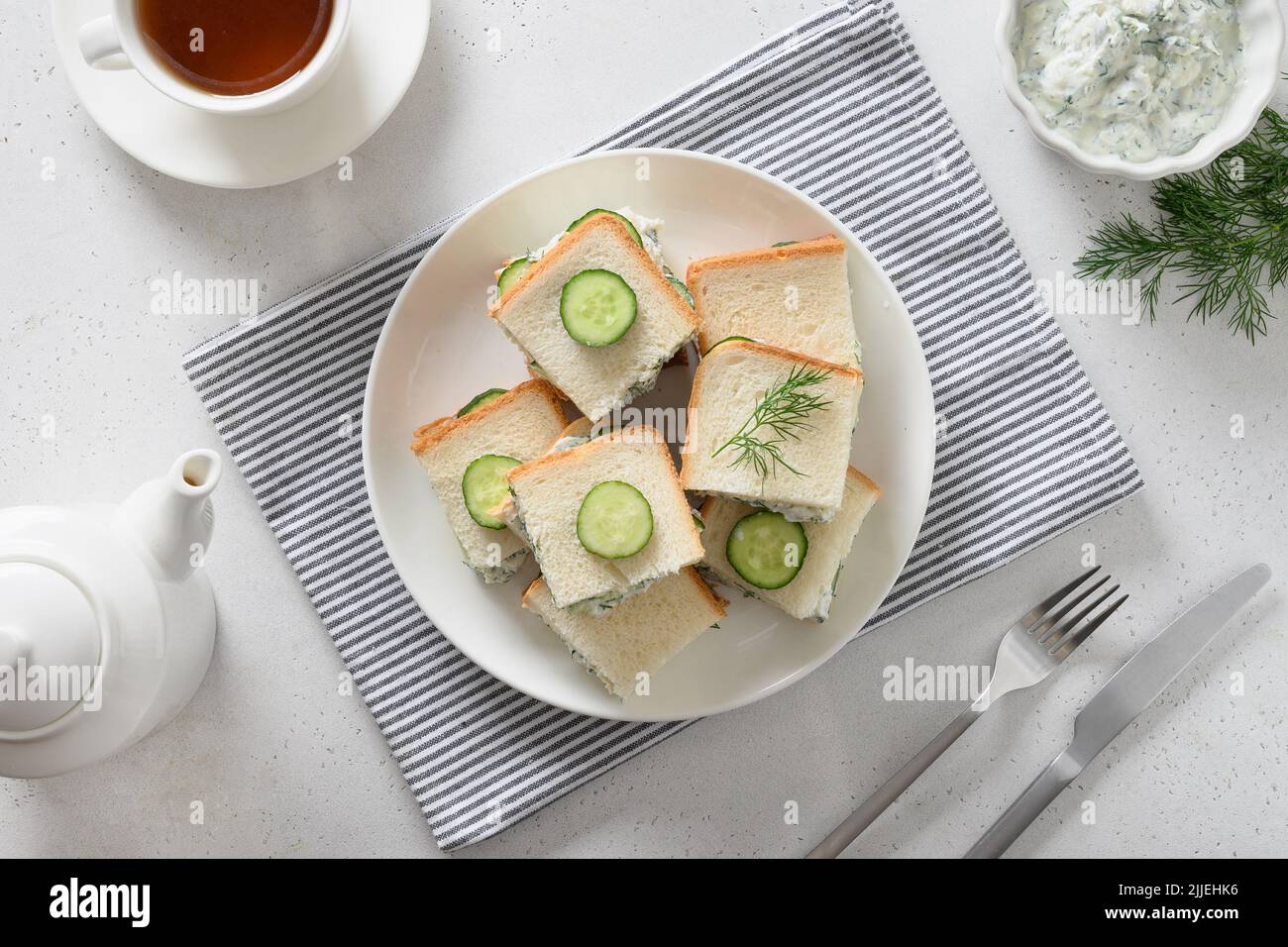 Homemade English tea cucumber sandwiches with ricotta and dill on white