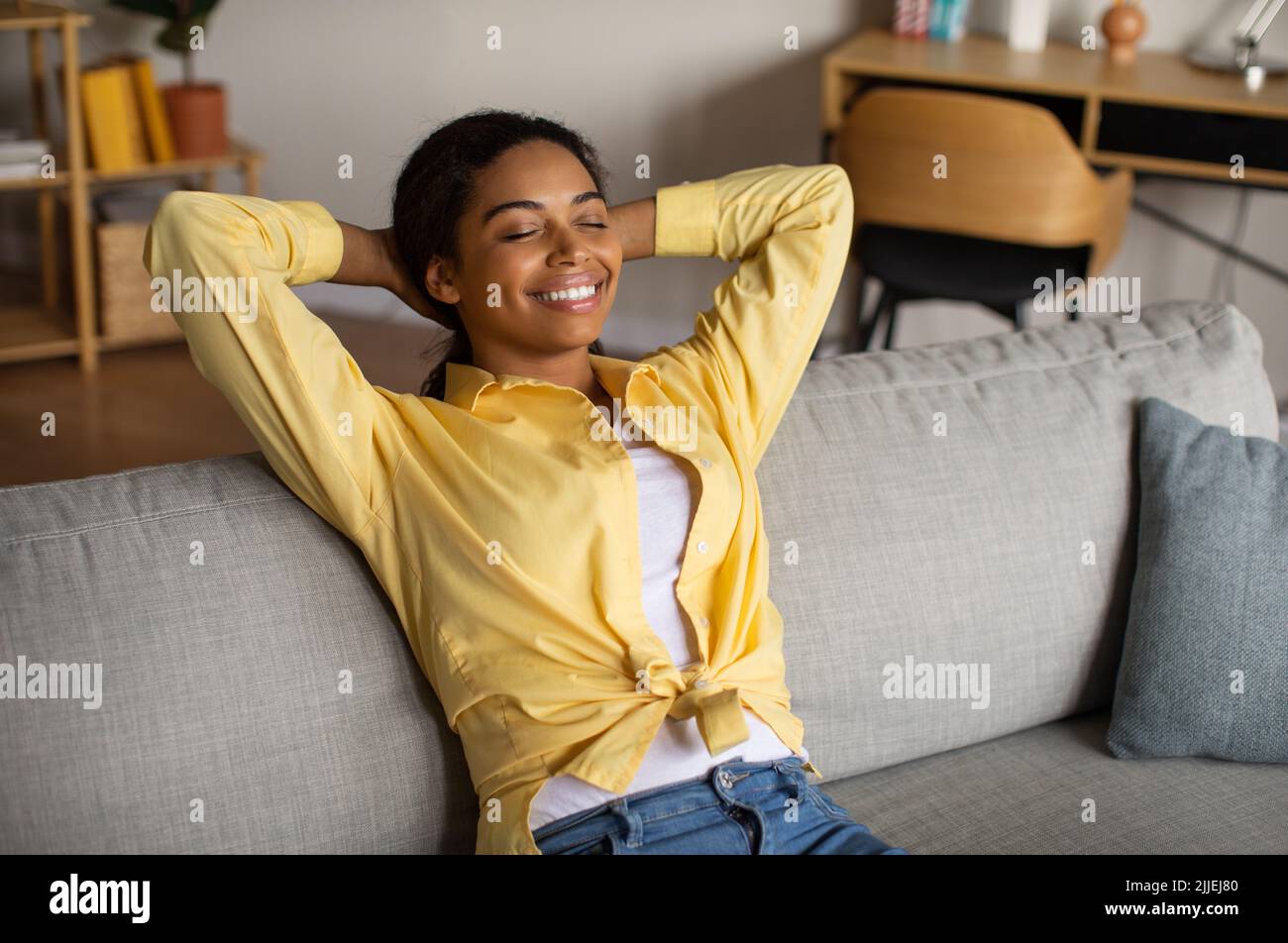 Cheerful woman sitting behind hi-res stock photography and images - Alamy