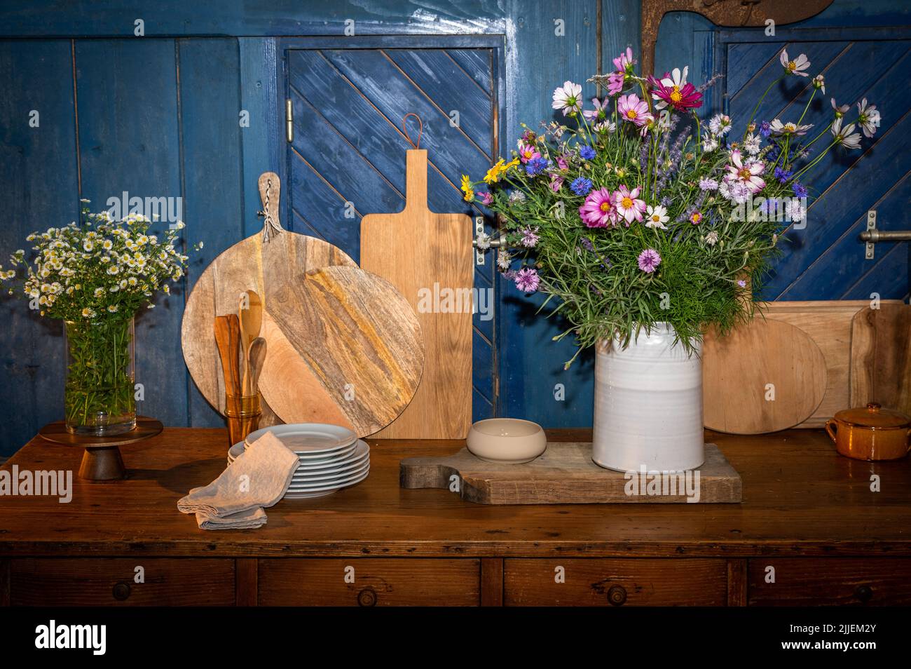 country decor vases, pots, boards and field flowers Stock Photo