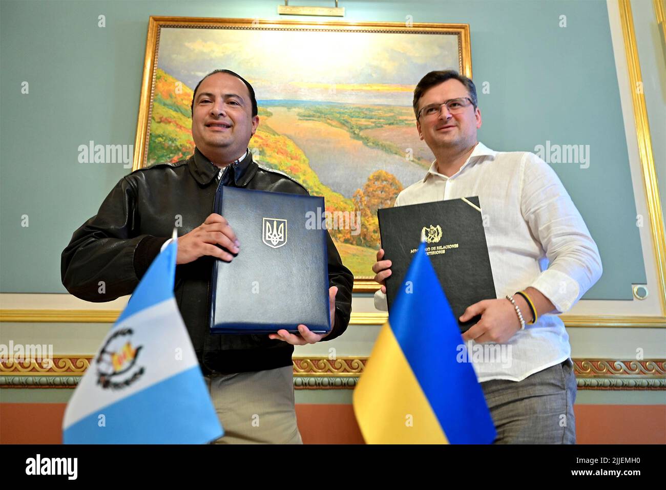 Kyiv, Ukraine. 25th July, 2022. Ukrainian Foreign Affairs Minister Dmytro Kuleba, right, and Guatemalan Foreign Minister Mario Bucaro, left, hold up a signed visa waiver agreement at the Mariinskyi Palace, July 25, 2022 in Kyiv, Ukraine. Credit: Ukrainian Presidential Press Office/Ukraine Presidency/Alamy Live News Stock Photo
