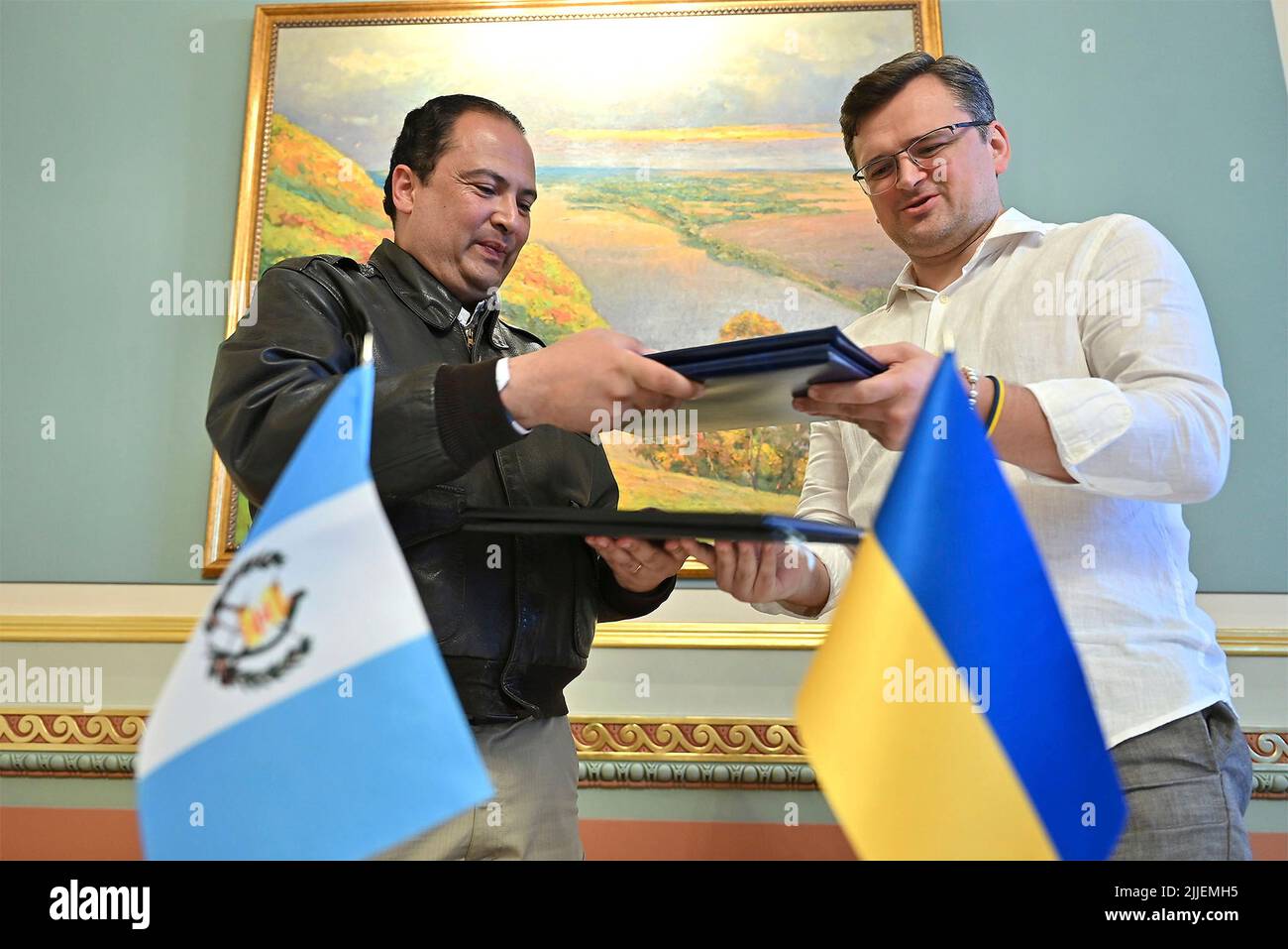 Kyiv, Ukraine. 25th July, 2022. Ukrainian Foreign Affairs Minister Dmytro Kuleba, right, and Guatemalan Foreign Minister Mario Bucaro, left, exchange copies of a signed visa waiver agreement at the Mariinskyi Palace, July 25, 2022 in Kyiv, Ukraine. Credit: Ukrainian Presidential Press Office/Ukraine Presidency/Alamy Live News Stock Photo