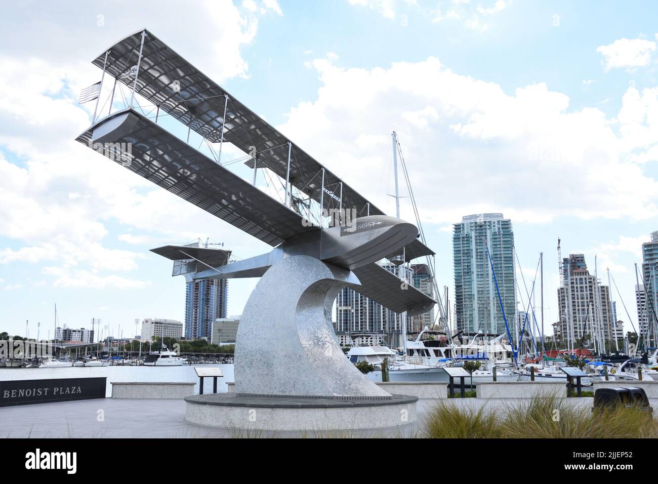 A sculpture monument of the Benoist Airboat at the Benoist Centennial Plaza, St. Pete Pier, Florida, USA. City high rise buildings in the background. Stock Photo
