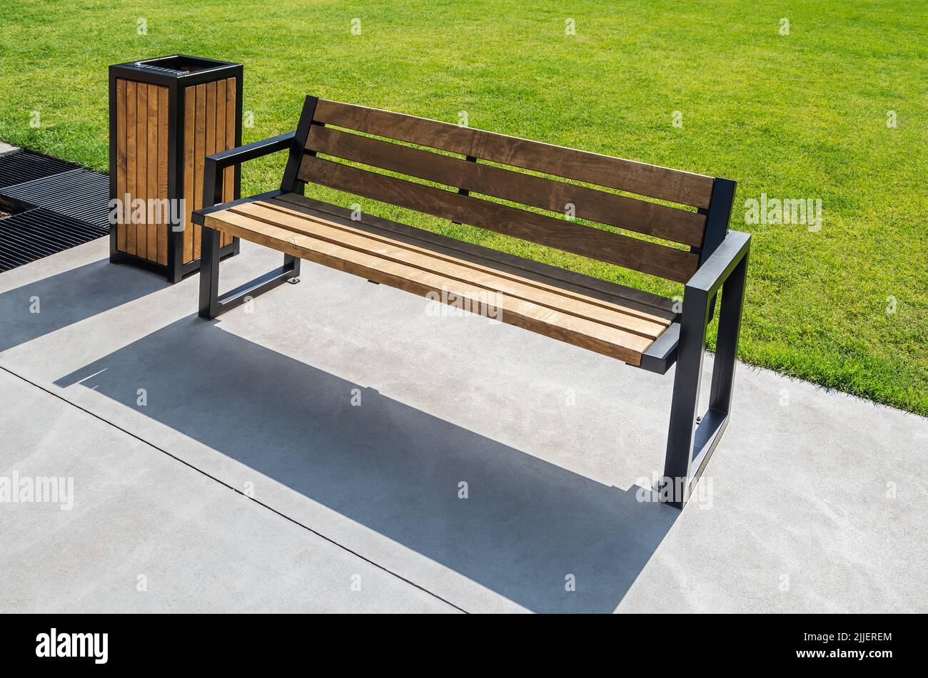 Wooden bench for rest and wooden garbage bin for waste in city park