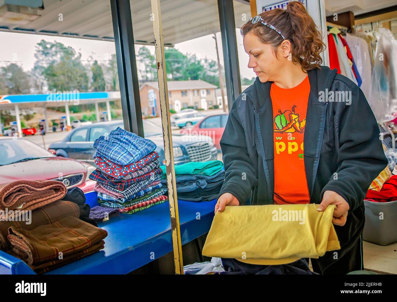 Woman folding laundry folding clothes hires stock photography and