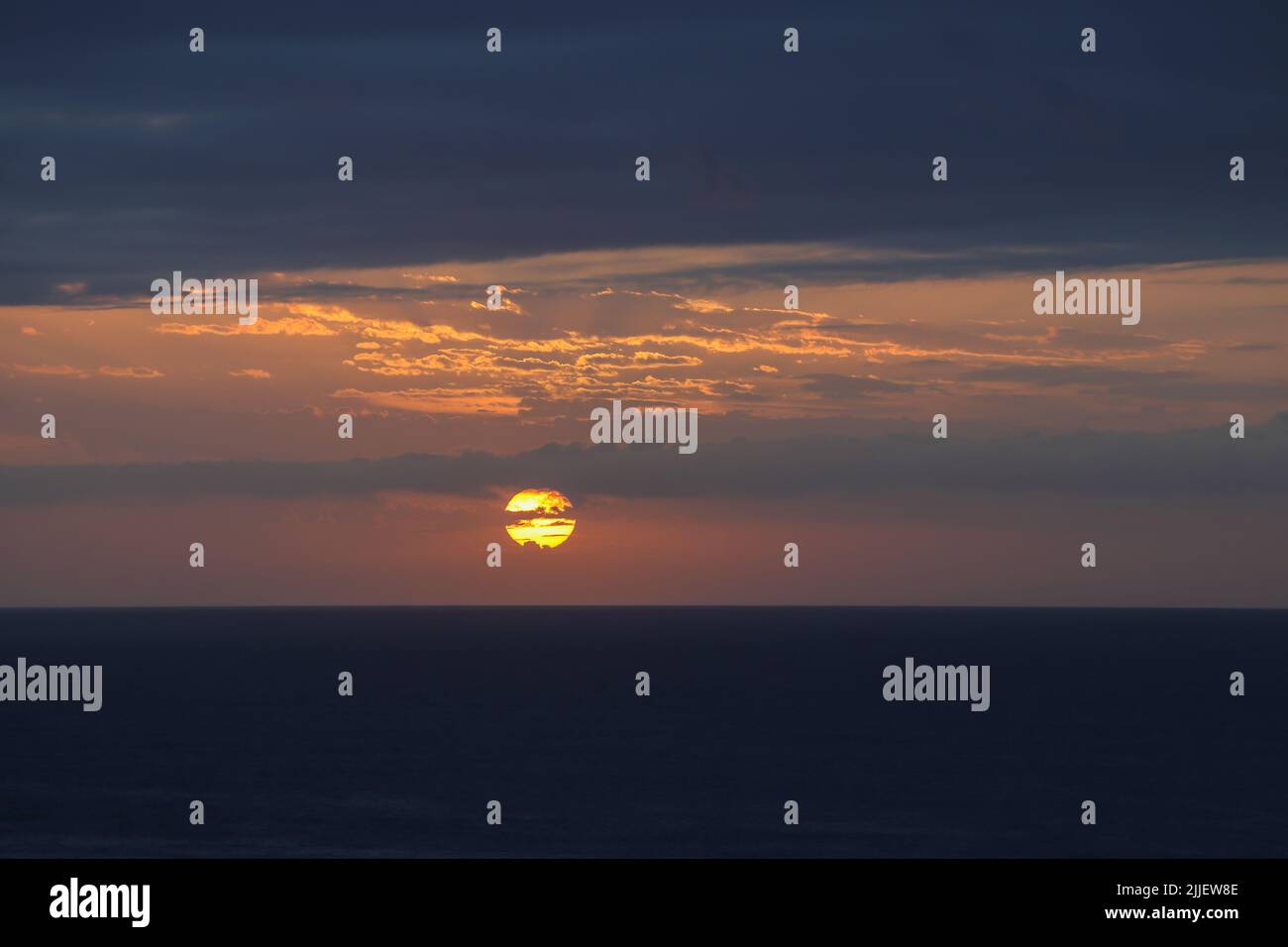 Dawn Break Sun Over Overcast Ocean Horizon Stock Photo
