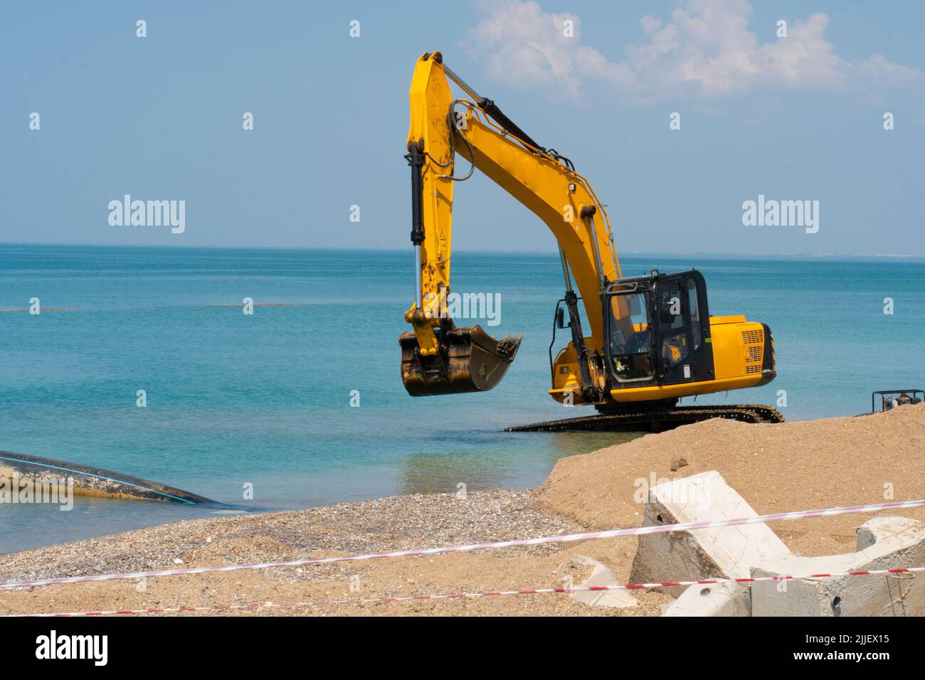 Excavator loading quarry truck dump tractor machinery machine loader heavy, from backhoe soil for dig and sky work, bucket crawler. Mud rotate yellow, Stock Photo