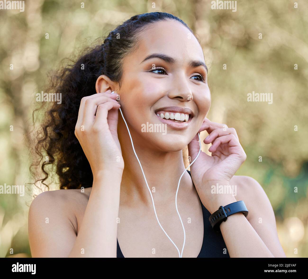 Getting all pumped up for her morning run. a sporty young woman ...