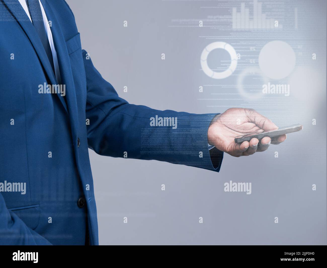 Accessing the world of finance. an unrecognizable businessman using his cellphone to open a virtual interface in studio against a grey background. Stock Photo
