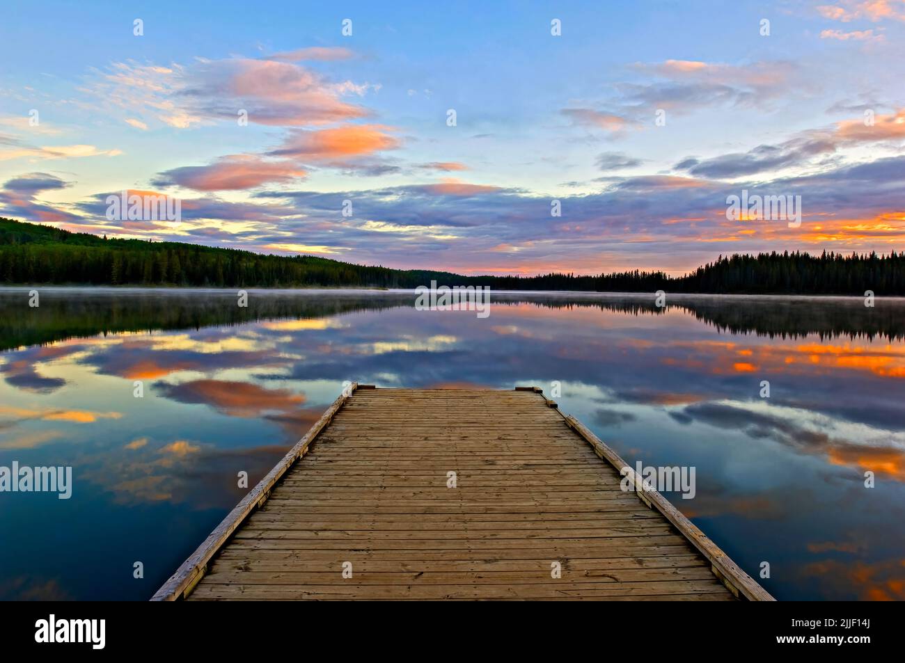 A early morning summer sunrise from the boat dock on Jarvis Lake in William A Switzer Provincial Park Alberta Canada. Stock Photo