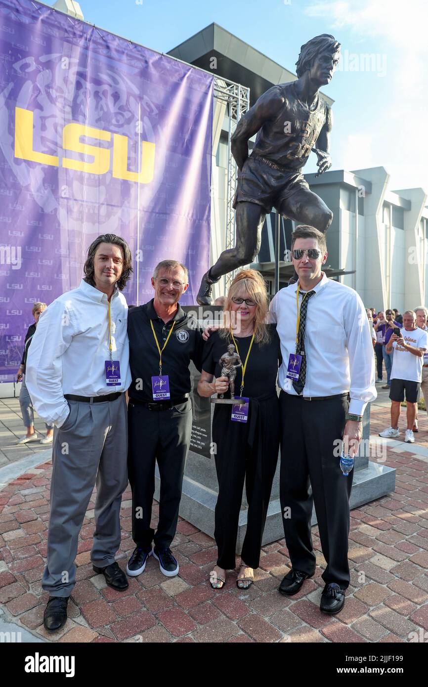 July 25, 2022 Jackie Maravich poses with the new statue with her son's