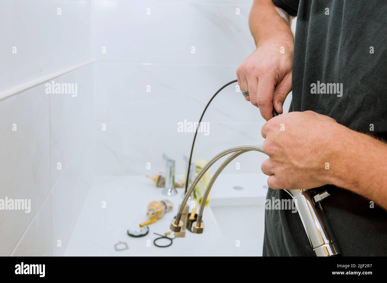 As a plumber at work, he is assembling and installing the water faucet