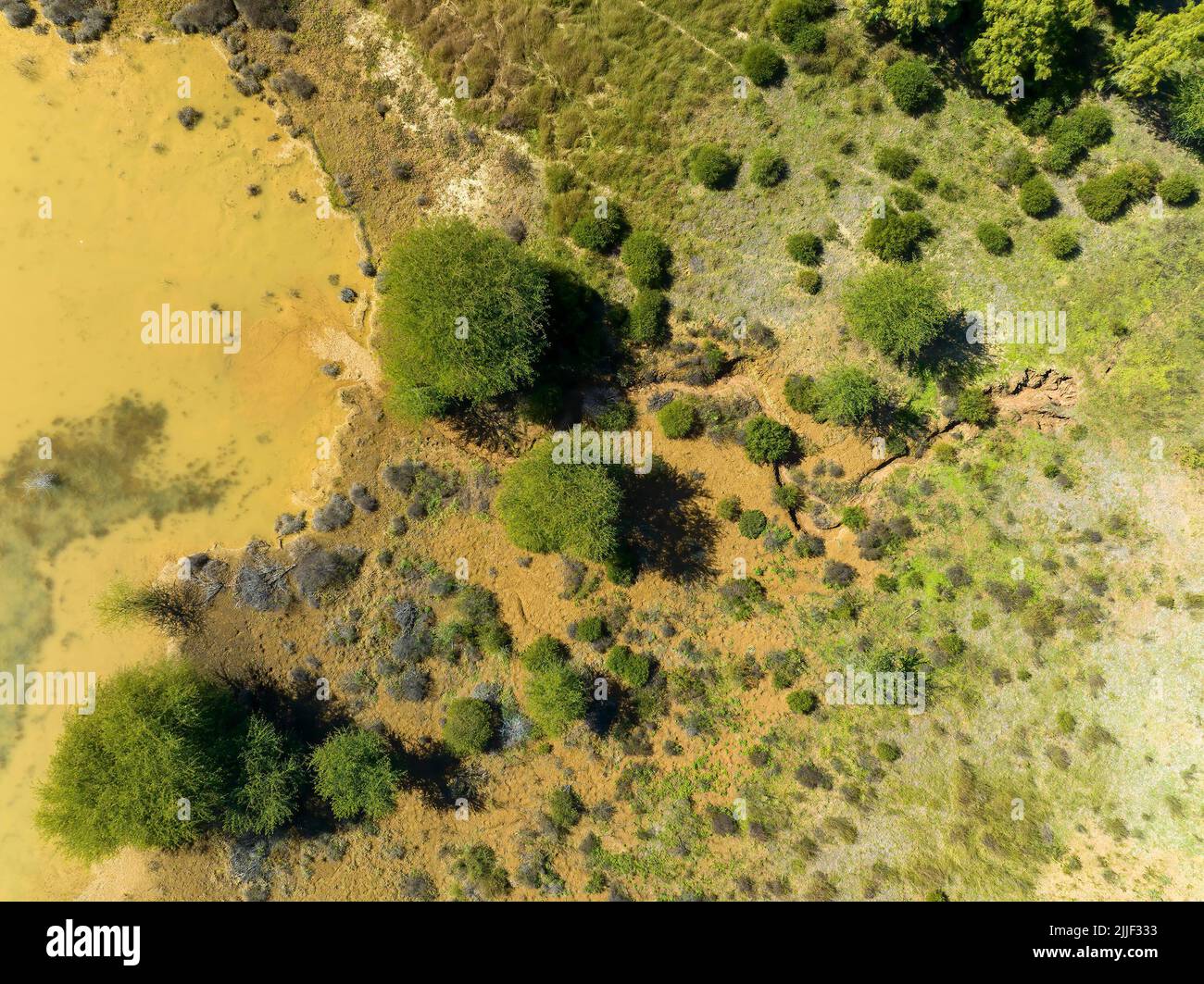 Drone aerial over water pond used for sapphire mining in central