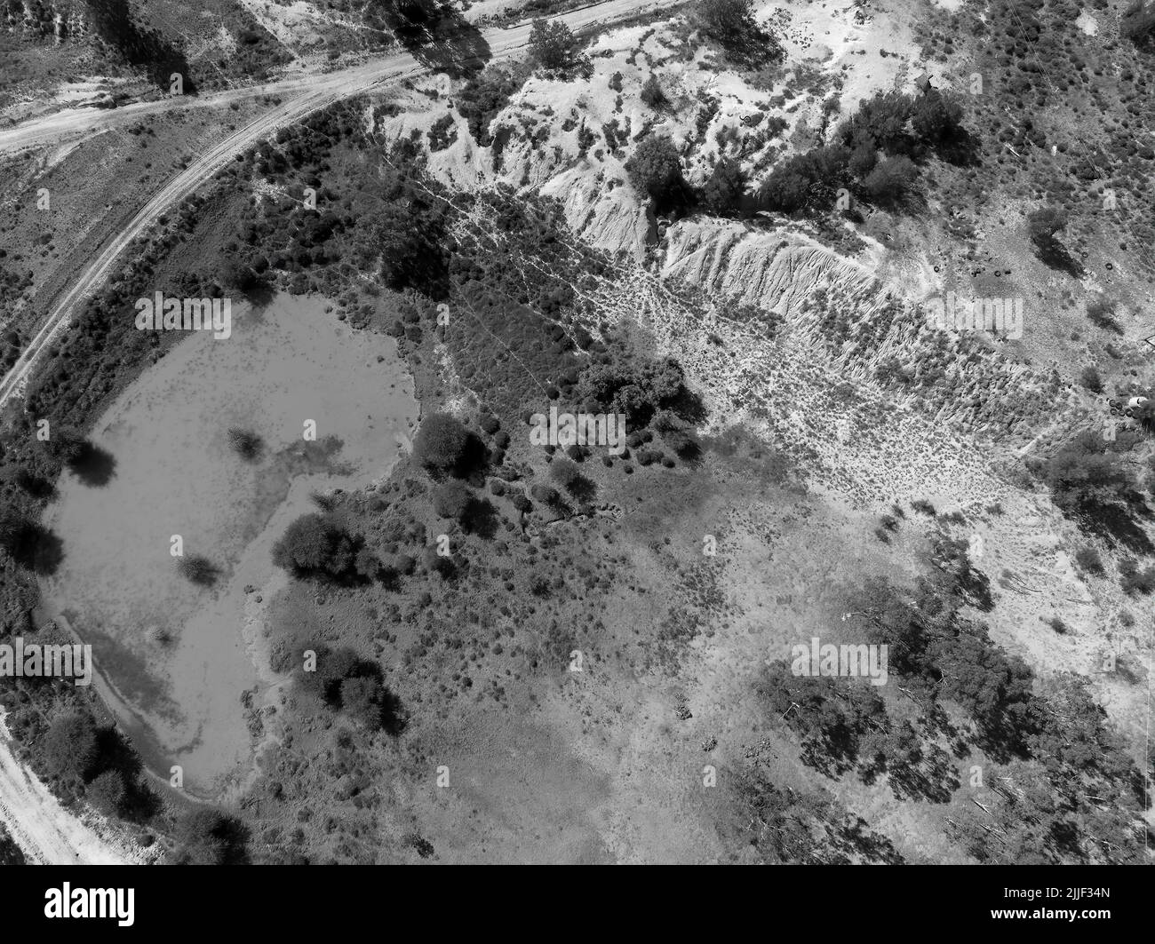 Drone aerial over water pond caused by sapphire mining in central