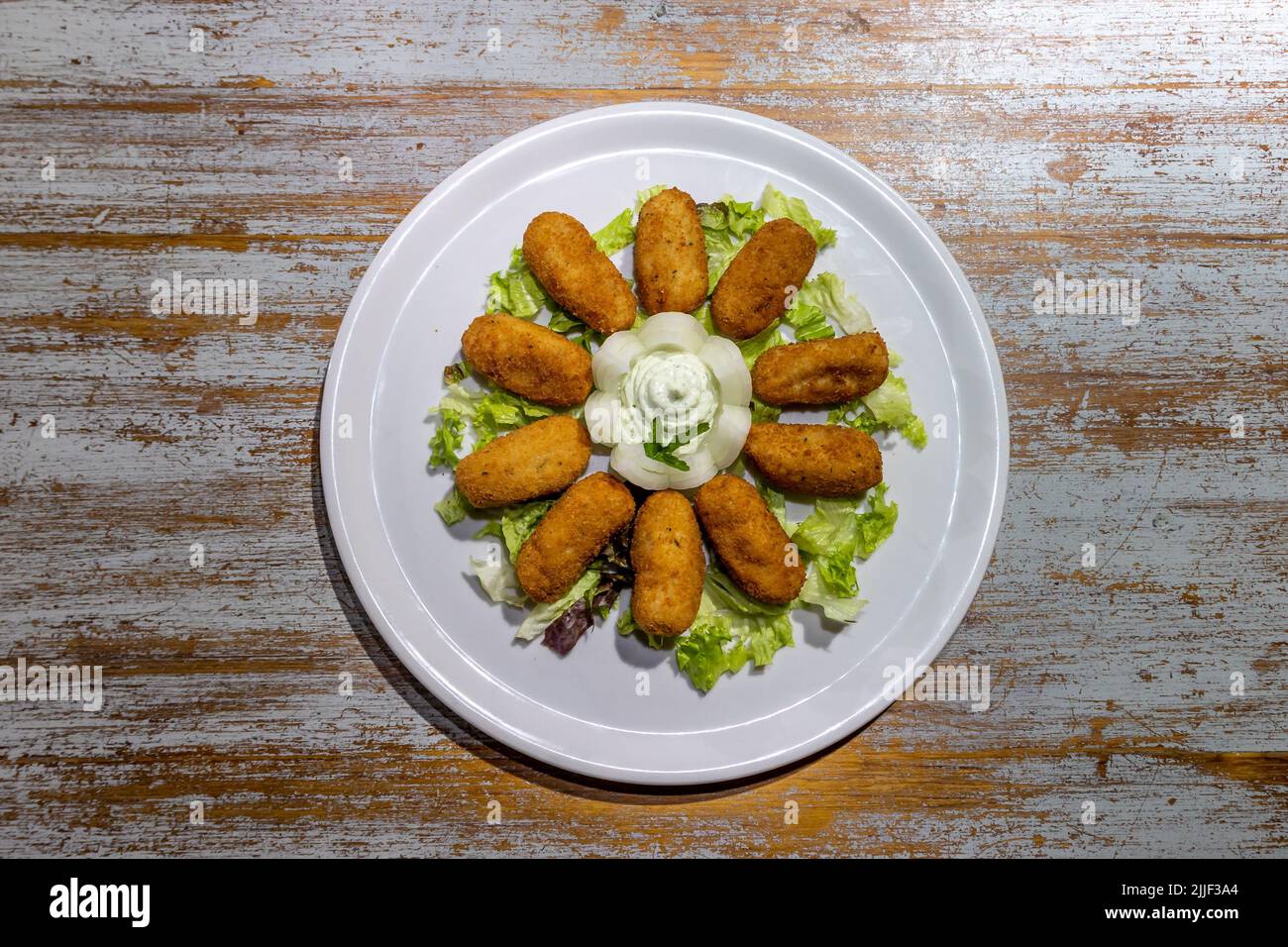 Fresh chicken croquettes with sauce, greens, and onions Stock Photo Alamy