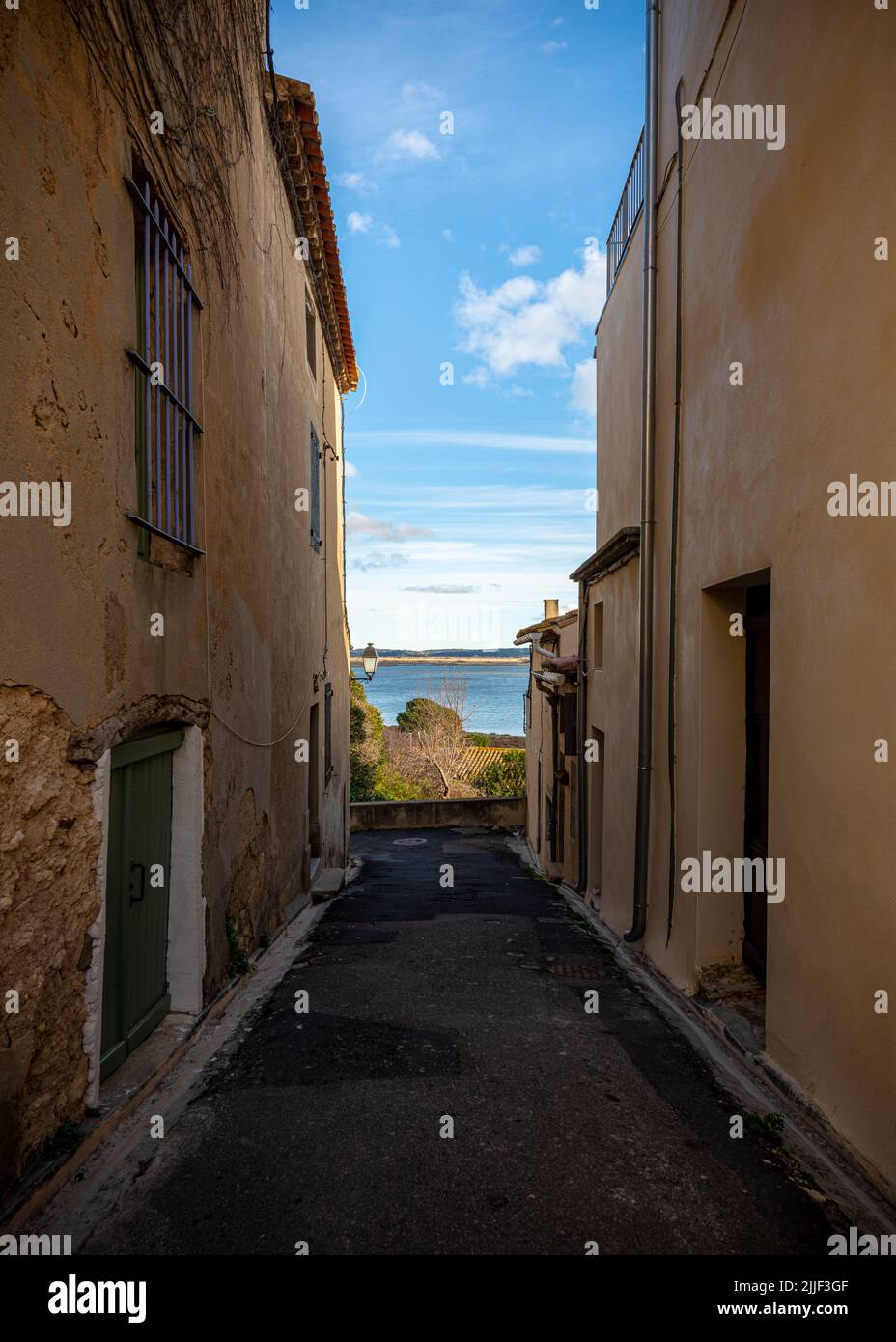 Old street of the village of Gruissan, Southern France, leading to a lake, taken on a sunny winter late afternoon with no people Stock Photo