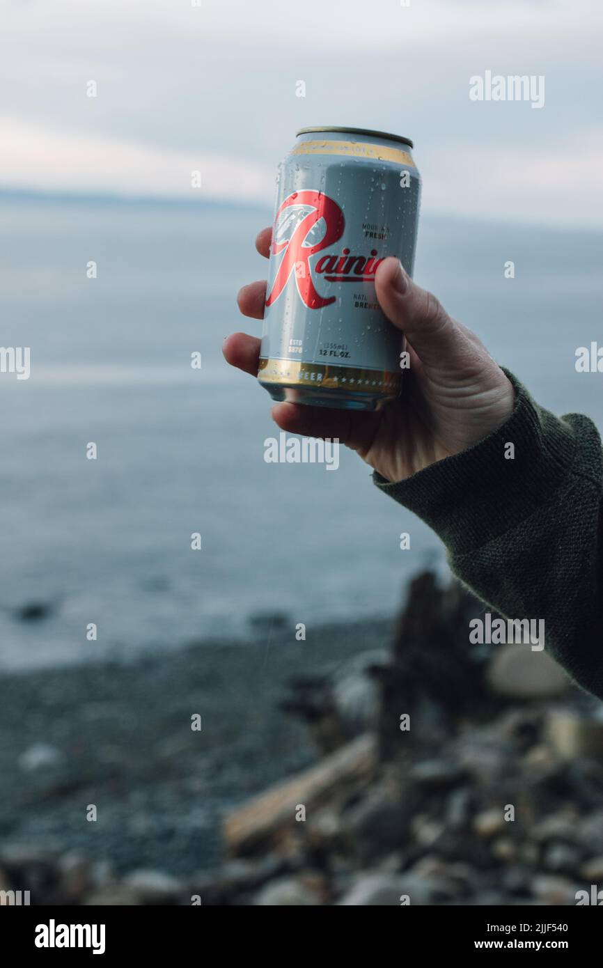 hand holding up can of Rainier beer near Port Angeles, WA April 4, 2019