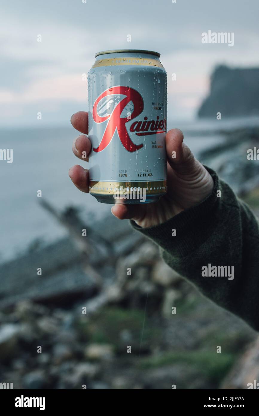 hand holding up can of Rainier beer near Port Angeles, WA April 4, 2019