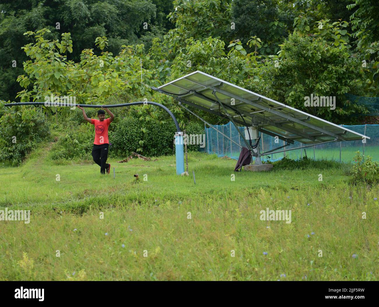 AGARTALA,TRIPURA,21-07-2022: Ripan Deb, a 37 years old farmer giving water in his field through solar-powered water pump which was installed in his field with the help of Government of Tripura,s subsidised policy in Gokulnagar, 24 km far from Agartala. PHOTO BY-ABHISEK SAHA Stock Photo