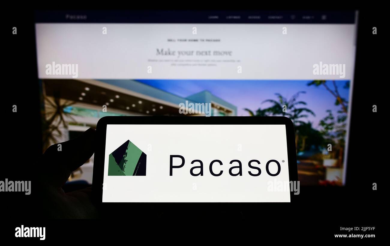 Person holding smartphone with logo of US real estate company Pacaso on