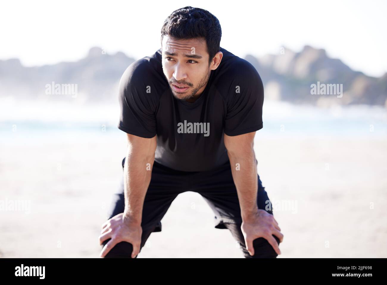 Its normal for a workout to wear you out. a handsome young male athlete