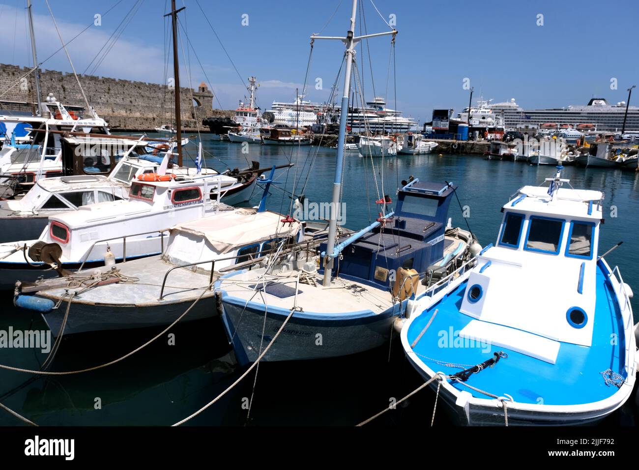 Boats moored in Mandraki Harbour on the island of Rhodes in Greece Stock Photo