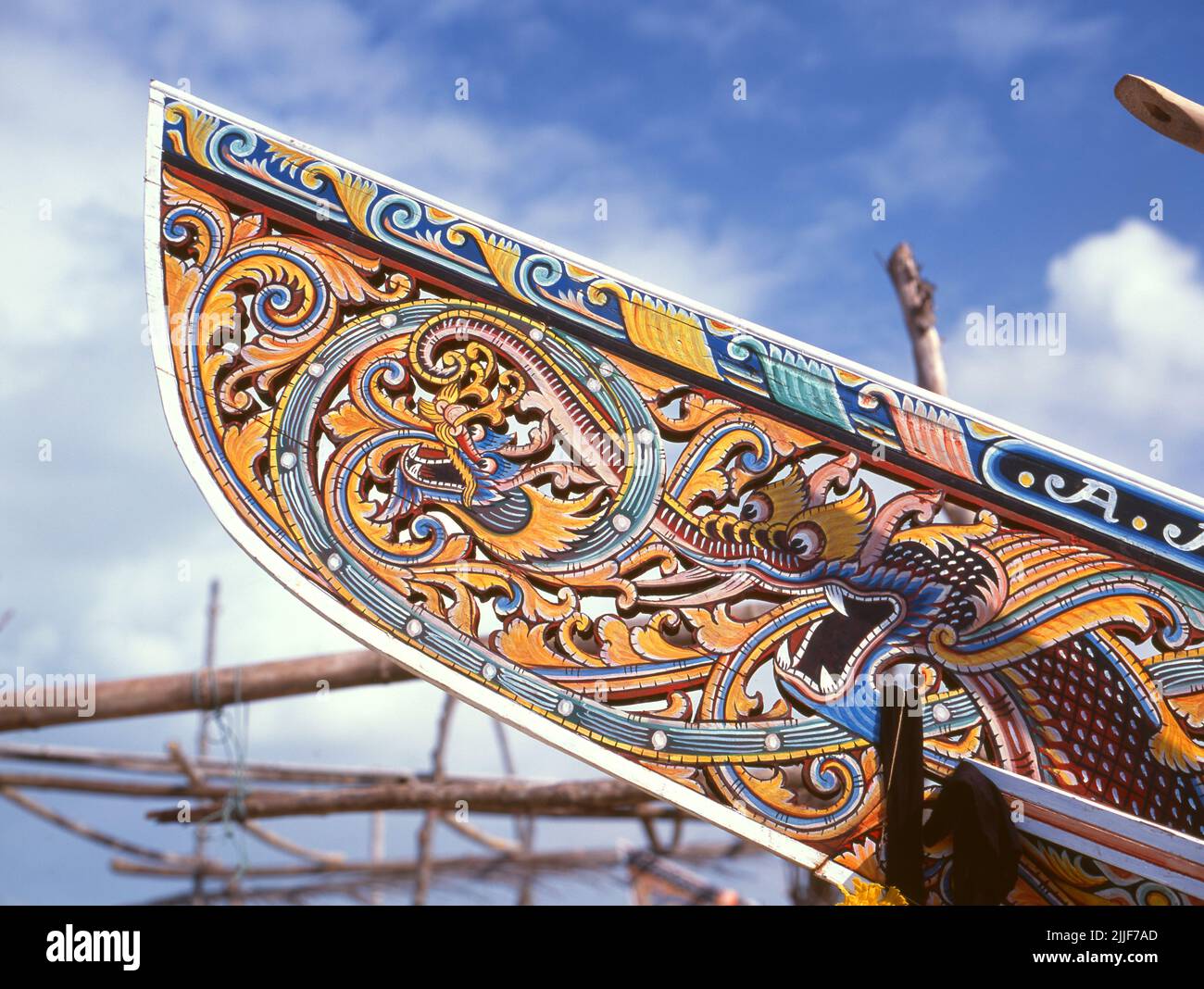 Thailand: Korlae fishing boats, Saiburi, southern Thailand. Along the east coast of peninsular Thailand, from Ko Samui southward, colorful, painted fishing boats have been built and decorated by Muslim fishermen for hundreds of years. The finest examples of this now declining industry originate in the boatyards of Saiburi District, Pattani Province. Among the characters depicted on the detailed hull designs are the singha lion, the gagasura horned bird, the payanak sea serpent, and the garuda bird that is both the symbol of the Thai Kingdom and the mythical mount of the Hindu God Vishnu. Stock Photo