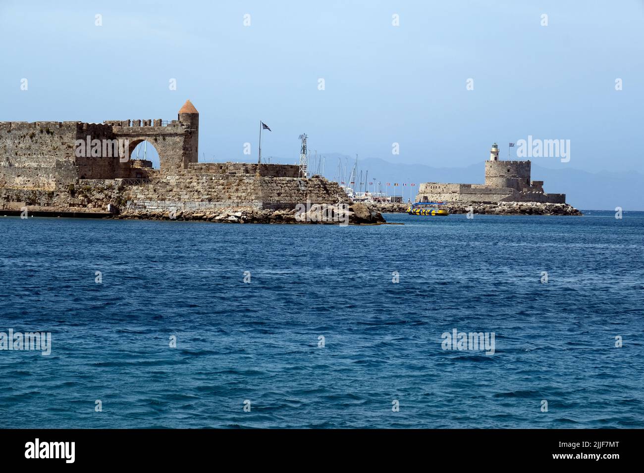 Looking towards the Fort of Saint Nicholas in Mandraki Harbour on the island of Rhodes in Greece Stock Photo