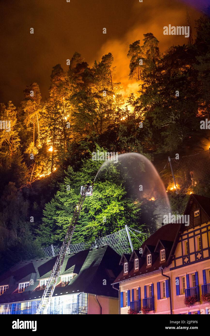Hrensko, Czech Republic. 25th July, 2022. Firefighter throws water on