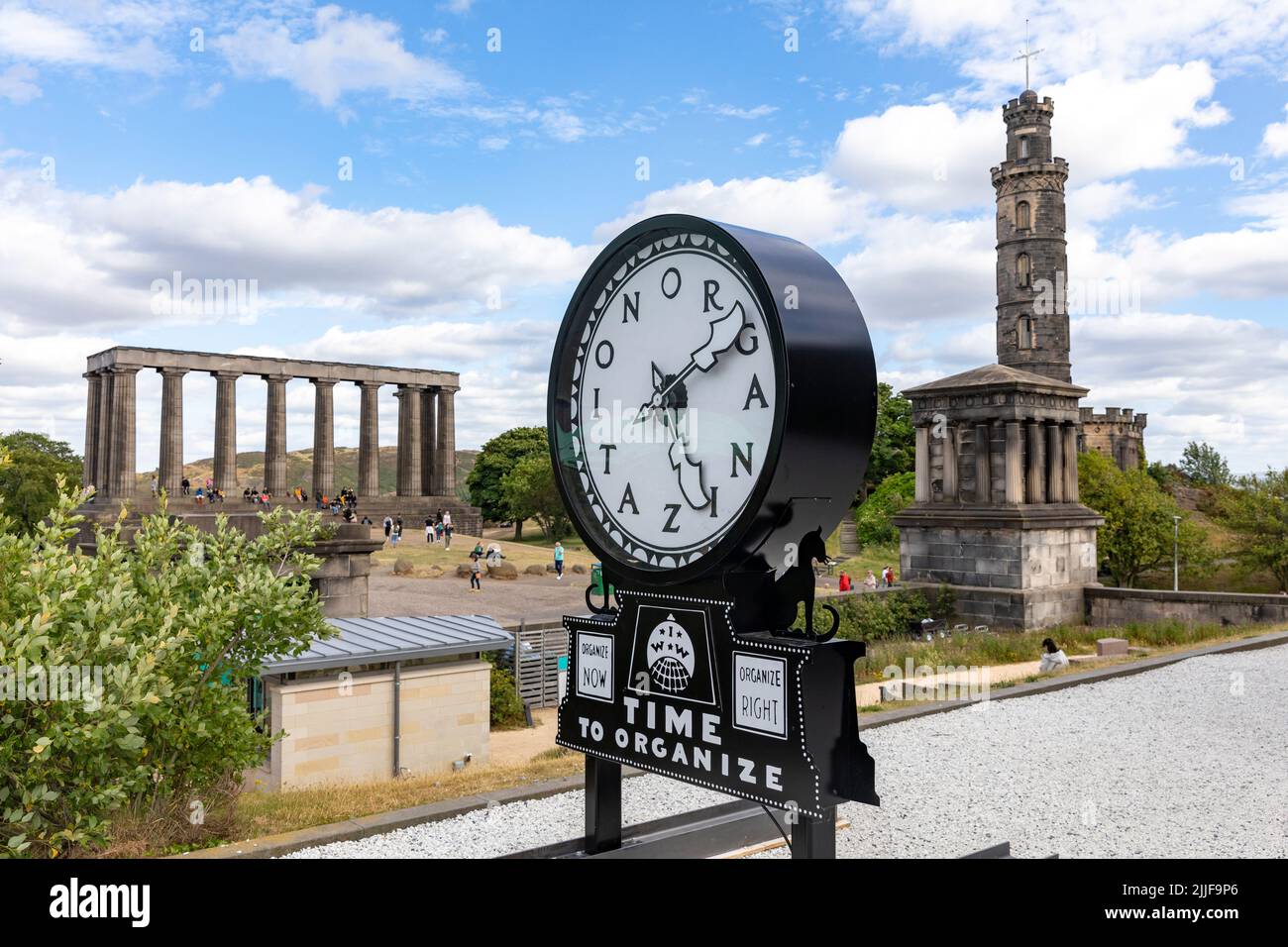 Calton Hill Edinburgh, Silent Agitator time to organise on display, Nelson Monument and the National Monument of Scotland behind,UK,Europe Stock Photo