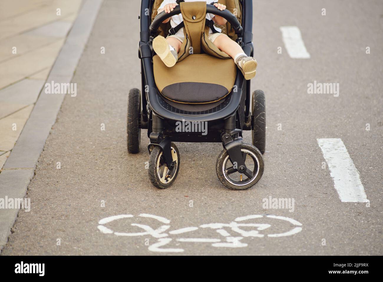 Happy toddler baby boy rides on a swing. Smiling child swinging on the ...