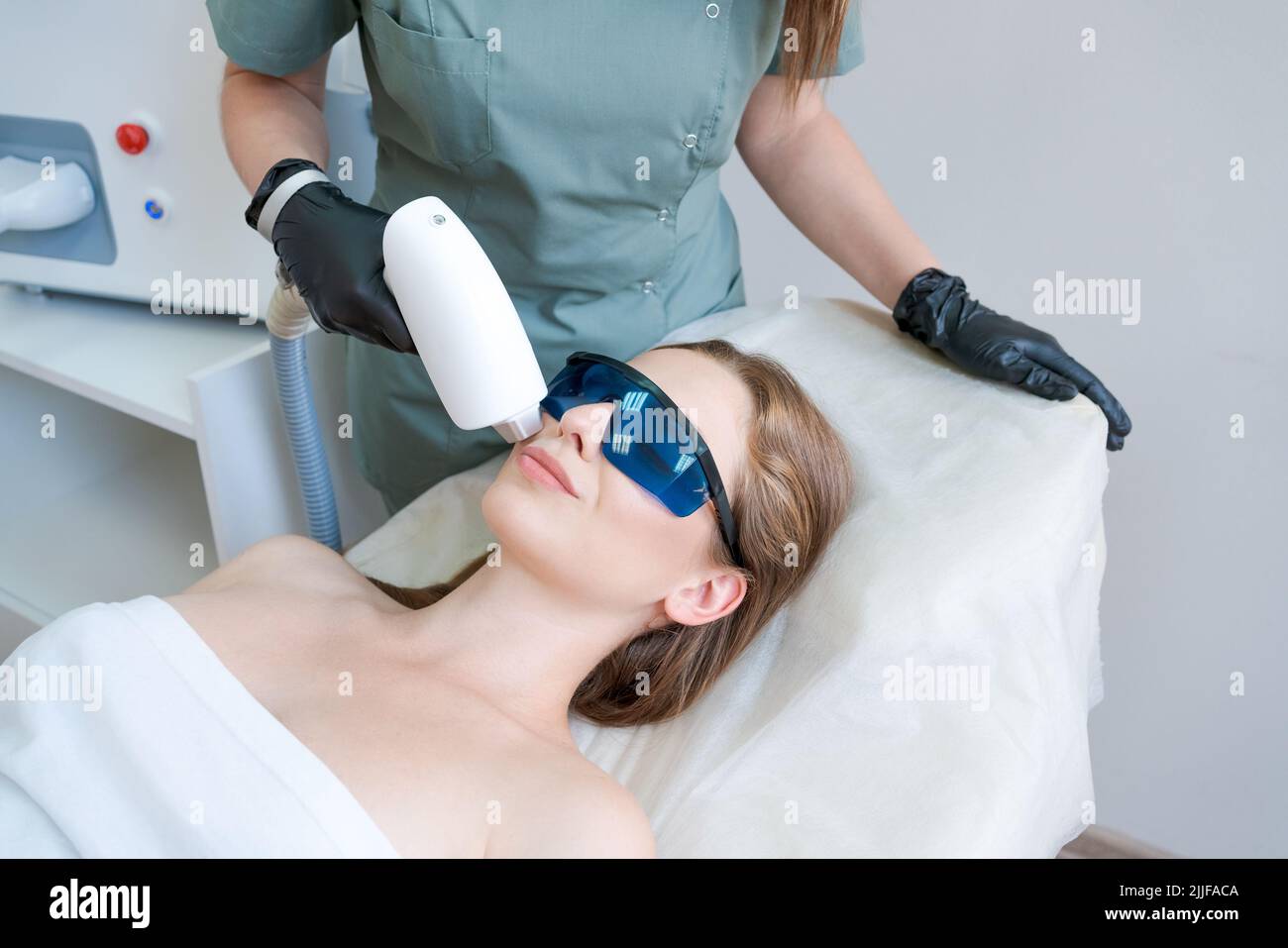 Therapist cosmetologist undergoes laser treatment on face young woman in  beauty clinic. Facial laser hair. Epilation procedures. Satisfied customer,  selective focus Stock Photo - Alamy