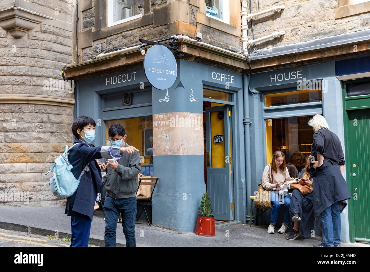 Hideout cafe coffee shop in upper bow, people wait for coffees, facemasks due to covid 19,Edinburgh old town,Scotland,UK summer 2022 Stock Photo