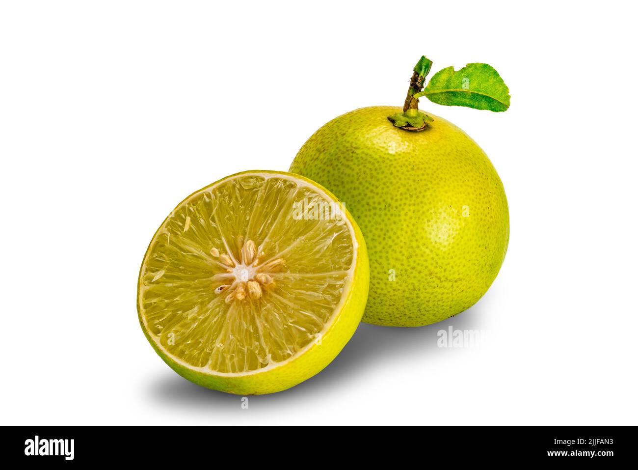 A half and a whole ripe lemon with green leaf isolated on white background with clipping path. Stock Photo
