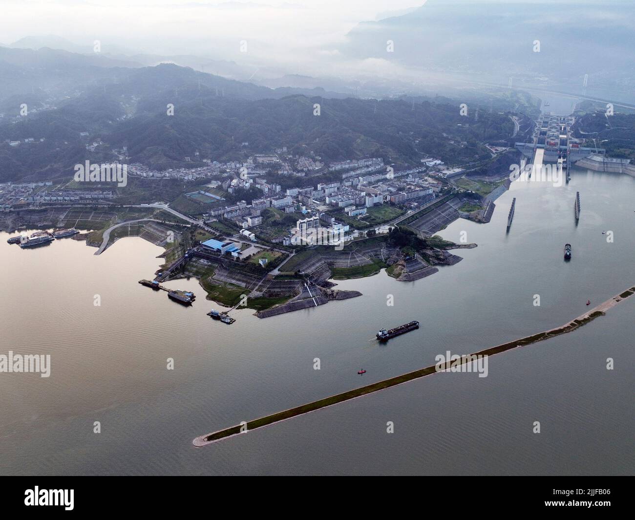 YICHANG, CHINA - JULY 25, 2022 - Aerial photo taken on July 25, 2022 shows ships passing through the five-level lock of the Three Gorges Dam in Yichan Stock Photo