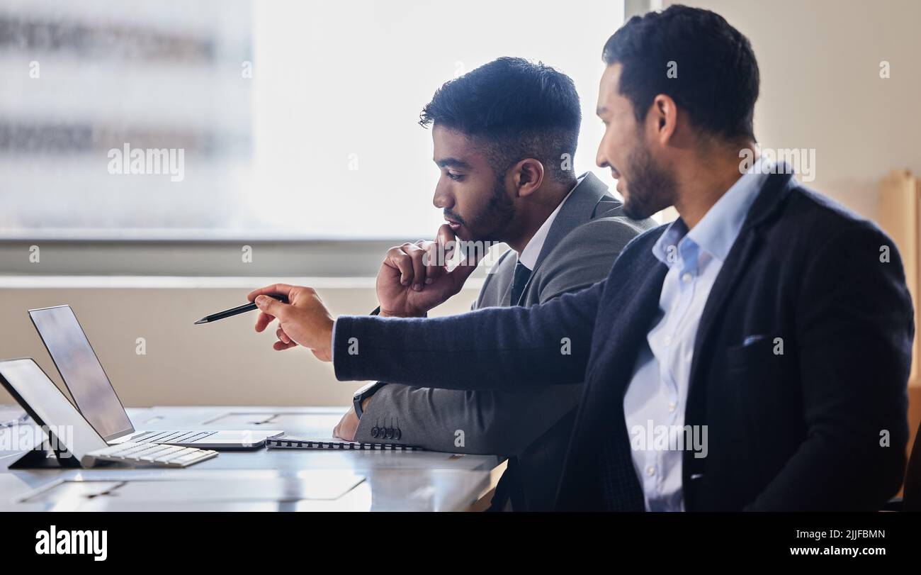 Thats our best bet. two businessmen discussing something on a laptop. Stock Photo