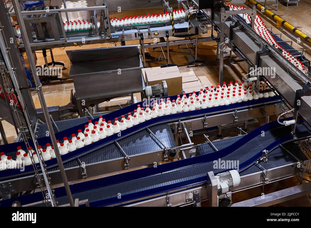 Plastic bottles with heattreated milk on conveyor belt Stock Photo Alamy