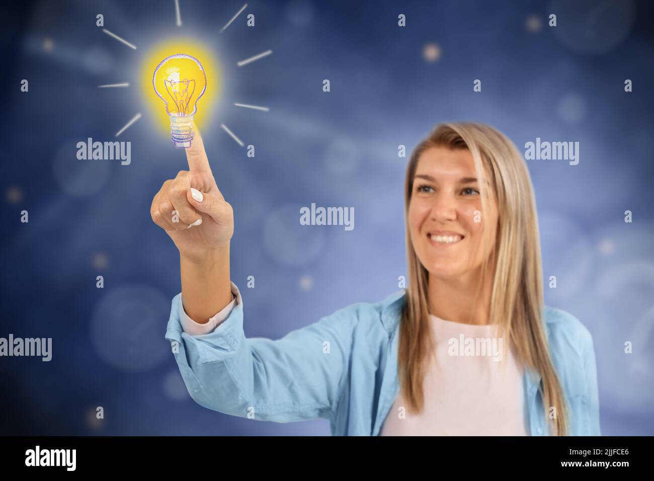 The girl clicks on the burning light bulb with an idea among the questions Stock Photo