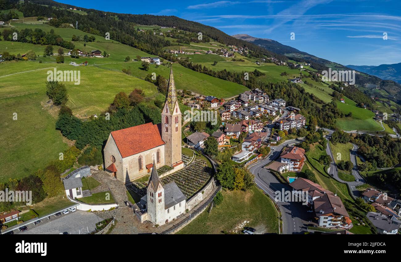 Villandro, Italy - Aerial view of the Church of St.Michael at the small village of Villandro (Villanders) on a sunny summer day with blue sky in Bolza Stock Photo