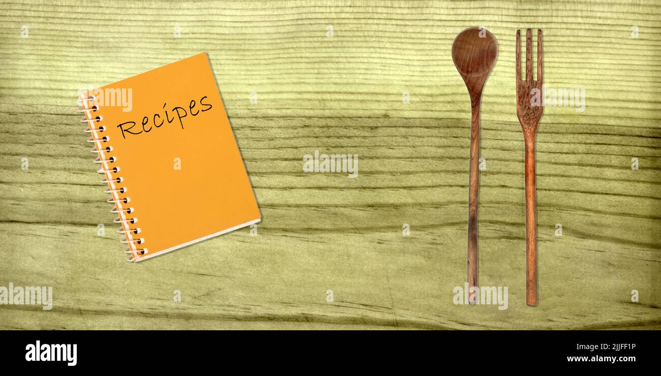 Utensils and vintage cooking book on wooden table hires stock