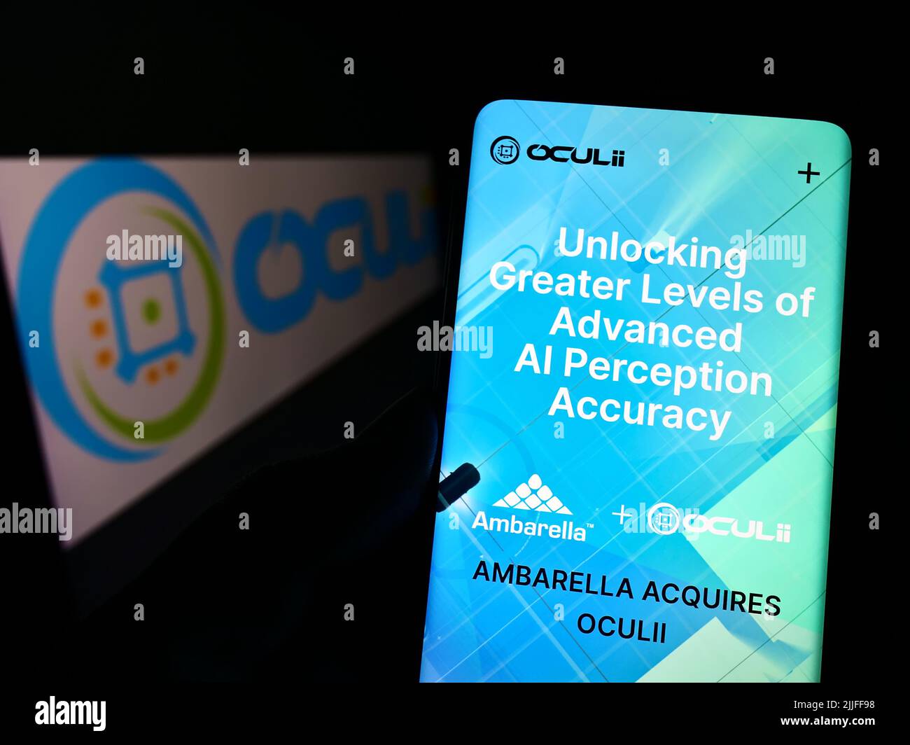 Person holding cellphone with webpage of US radar technology company Oculii on screen in front of logo. Focus on center of phone display. Stock Photo