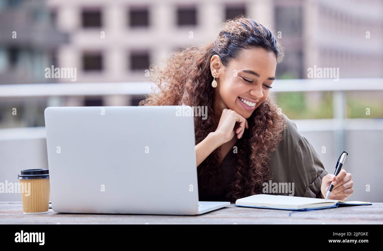Work Refreshing View Refreshing her mind. a young businesswoman using a laptop and notebook ...