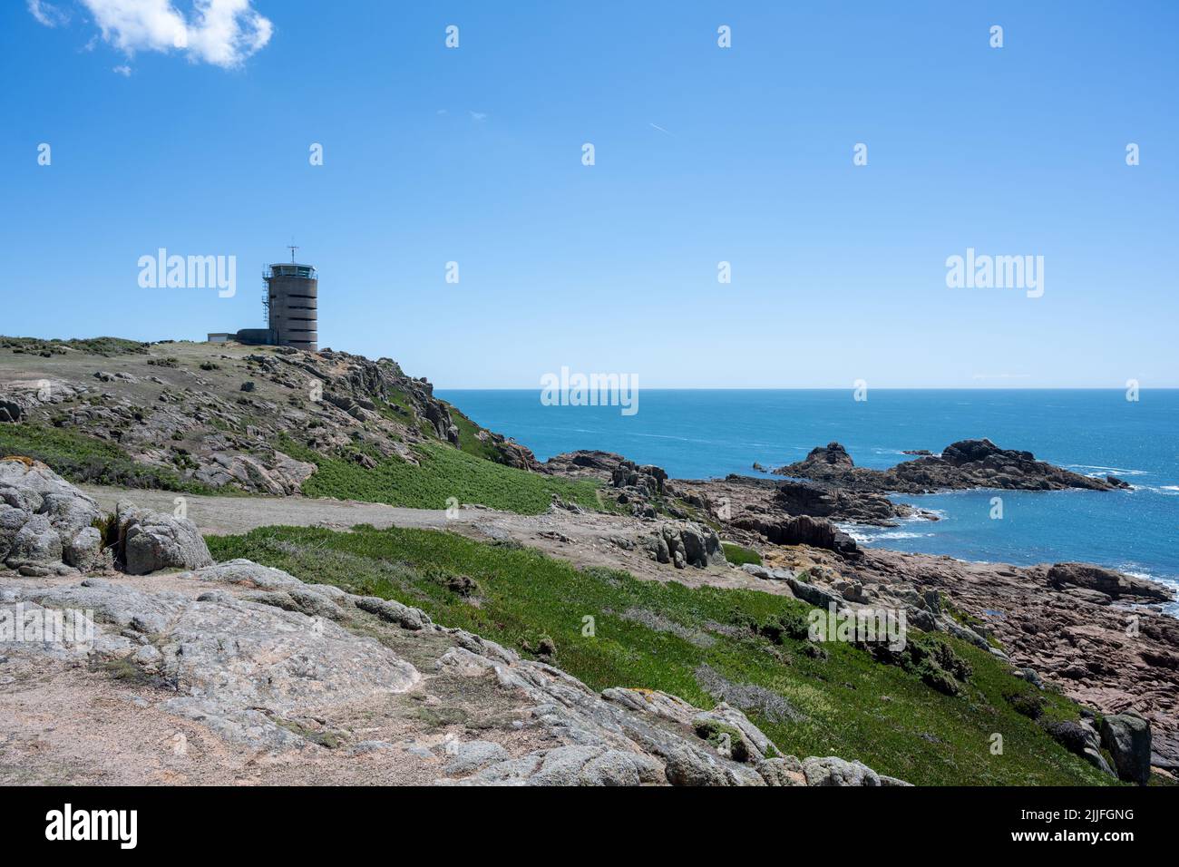 La Corbiere WW2 watchtower on the headland of St Brelade in the south-west of the British Crown Dependency of Jersey, Channel Islands, British Isles. Stock Photo