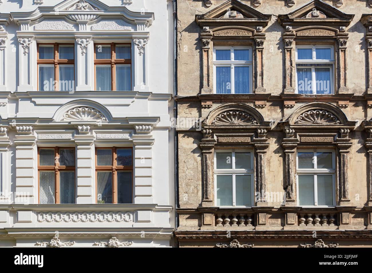Old and new old building facade after renovation compared as background texture Stock Photo